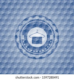 hanger with towel icon inside blue emblem or badge with geometric pattern background.