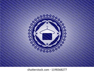 hanger with towel icon inside emblem with denim texture
