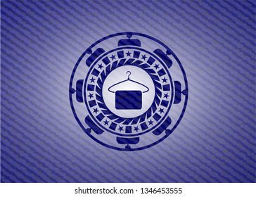 hanger with towel icon inside emblem with denim texture
