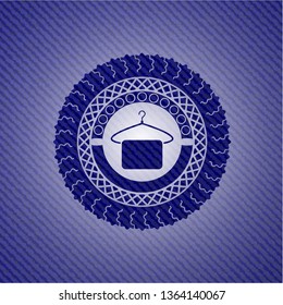 hanger with towel icon inside emblem with denim texture