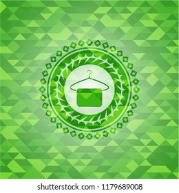 hanger with towel icon inside green emblem. Mosaic background