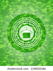hanger with towel icon inside green emblem with mosaic ecological style background