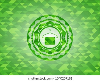 hanger with towel icon inside green emblem. Mosaic background