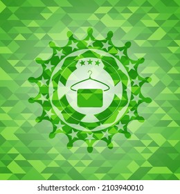 hanger with towel icon inside green emblem with mosaic ecological style background. 