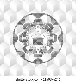 hanger with towel icon inside grey icon or emblem with geometric cube white background