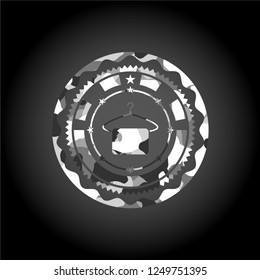 hanger with towel icon inside grey camouflaged emblem