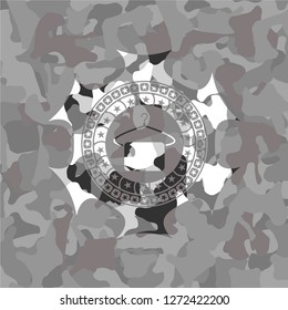 hanger with towel icon inside grey camouflage emblem