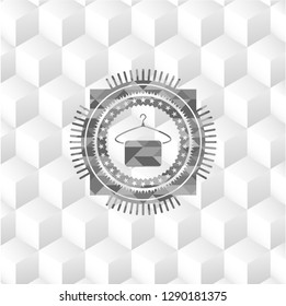 hanger with towel icon inside grey emblem with geometric cube white background