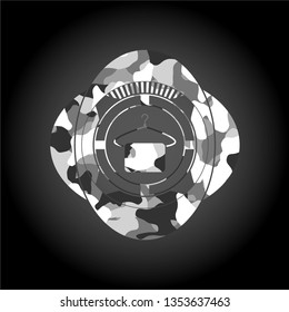 hanger with towel icon inside grey camouflage emblem