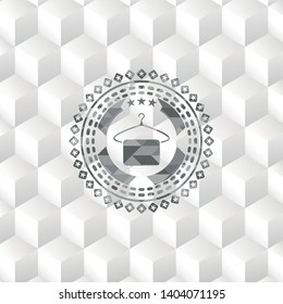 hanger with towel icon inside grey emblem with geometric cube white background