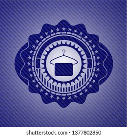 hanger with towel icon inside jean or denim emblem or badge background