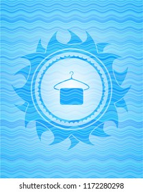 hanger with towel icon inside light blue water emblem.