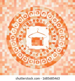 hanger with towel icon inside orange mosaic emblem