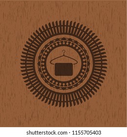 hanger with towel icon inside realistic wood emblem