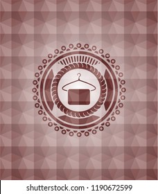 hanger with towel icon inside red emblem or badge with abstract geometric polygonal pattern background. Seamless.