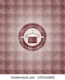 hanger with towel icon inside red badge with geometric pattern background.  