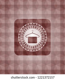 hanger with towel icon inside red seamless emblem or badge with abstract geometric pattern background.