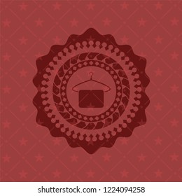 hanger with towel icon inside red icon or emblem