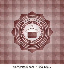 hanger with towel icon inside red seamless badge with geometric background.