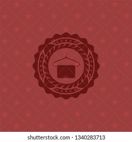 hanger with towel icon inside red emblem