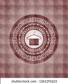 hanger with towel icon inside red seamless emblem or badge with abstract geometric polygonal pattern background.