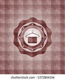 hanger with towel icon inside red seamless geometric emblem.