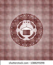 hanger with towel icon inside red seamless badge with geometric pattern.