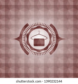 hanger with towel icon inside red seamless emblem or badge with abstract geometric pattern background.