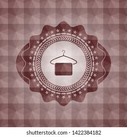 hanger with towel icon inside red seamless emblem or badge with abstract geometric pattern background.