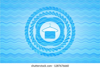 hanger with towel icon inside sky blue water wave badge background.