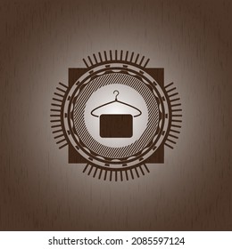 hanger with towel icon inside vintage wooden emblem. 
