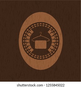 hanger with towel icon inside wood badge or emblem