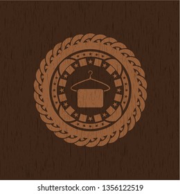 hanger with towel icon inside wooden emblem. Retro