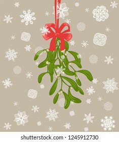 Hanging Christmas decoration with bunch of mistletoe with berries and red bow and paper cutting snowflakes