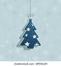 hanging christmas tree decoration on blue snowflake background