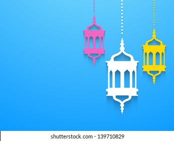 Hanging colorful Arabic lamps or lanterns on blue background, concept for Muslim community holy month Ramadan Kareem or Ramazan Kareem.