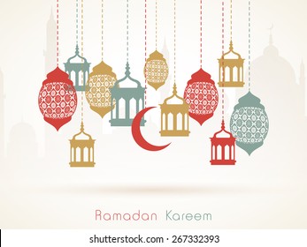 Hanging colorful arabic lamps or moon on islamic mosque silhouette background for holy month of muslim community, Ramadan Kareem celebration.