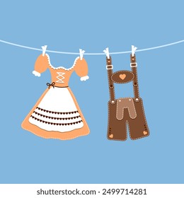 hängendes Dirndl und Lederhosen orange braun blauer Hintergrund