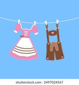 hängendes Dirndl und Lederhosen rosafarbener brauner blauer Hintergrund