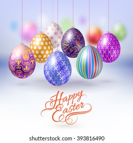 Hanging Easter Eggs with Different Ornaments on Blur Background