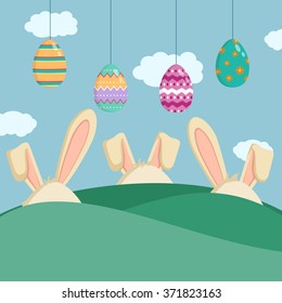 Hanging Easter Eggs With Rabbits Head on Green Field