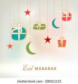 Hanging gift boxes, moon and stars on colourful shiny background for Eid Mubarak celebrations.
