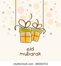 Hanging gift boxes on colourful dots background for Eid Mubarak festival celebrations. 