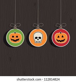 hanging halloween decorations on dark wood background