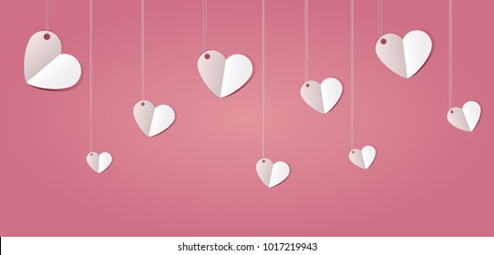 Hanging hearts on pink background