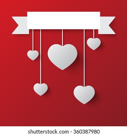 hanging hearts and ribbon on background