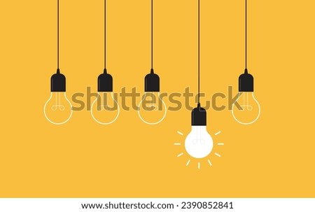 Hanging light bulbs with one glowing on yellow background. Concept of idea