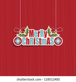 Hanging Merry Christmas Text decoration with baubles and holly on a red background with transparencies