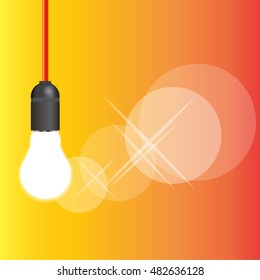 hanging on the wire twisted into a cartridge burning light bulb