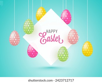 Hanging Painted Eggs and Happy Easter Message Card or Frame on Light Blue Background.